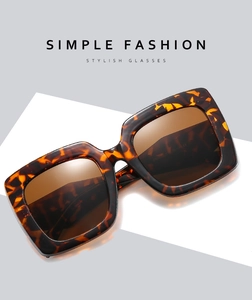 Detail of square oversized tortoiseshell sunglasses with brown lenses on modern background