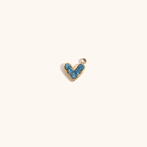 Detailed view of 14K gold-plated heart pendant with five faceted blue crystals