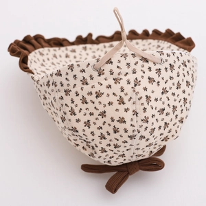 Vintage floral baby sun hat with brown bow tie and scalloped edges for girls