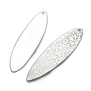 Detailed view of oval stainless steel pendants with smooth and leopard texture finishes