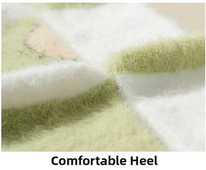 Detail of soft green and white plush fuzzy socks featuring a comfortable heel design