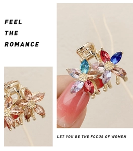Detail of small flower hair claw clip with colorful crystals and champagne finish