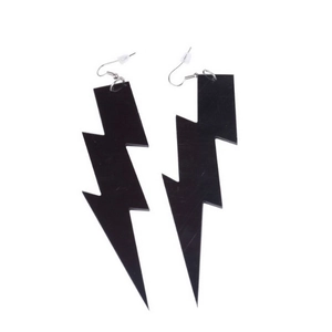 Close-up of oversized black acrylic lightning bolt earrings with silver hooks for women