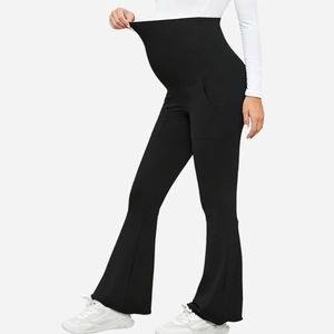 Detail view of the high waist elastic belly support on black maternity flare yoga pants