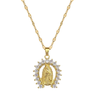Gold Virgin Mary pendant necklace with sparkling cubic zirconia on a white background