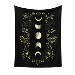 Detailed view of the moon phase tapestry with watercolor plants on black fabric