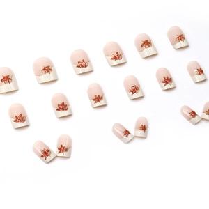 Short square press-on nails with creamy white French tips and red maple leaf designs
