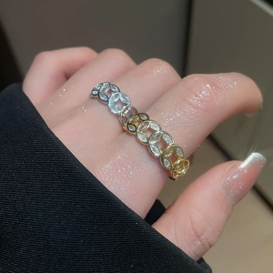 Detail of 18k gold plated open ring with zircon paving and unique coin pattern design