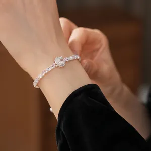 Silver bracelet with pink and white cubic zirconia crystals shown on a wrist