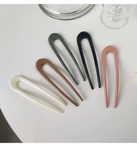 U-shaped hair pins in five colors including cream and olive green on a white background