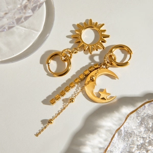 Gold celestial tassel earrings featuring sun and moon stars with sparkling rhinestones