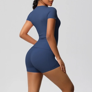 Detail of high-stretch navy blue yoga set showing slim fit short sleeves and tight shorts