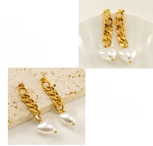 Macro detail of 18K gold plated long chain earrings with white heart pearl pendants