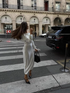 Elegant off-shoulder white knitted midi dress with a slim fit and long sleeves for women