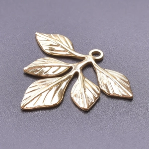 Detailed view of a golden 18k plated stainless steel leaf branch charm for DIY jewelry