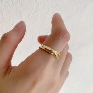Close-up of S925 silver gold-plated ring featuring irregular lava texture on finger
