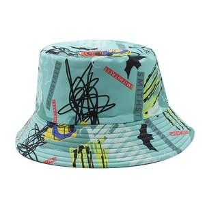 Detailed view of blue bucket hat featuring street graffiti prints and reinforced brim stitching