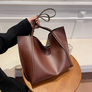 Large dark brown vintage leather tote bag with long shoulder straps for women