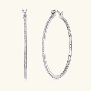 Macro detail of silver large hoop earrings with micro-pave moissanite stones