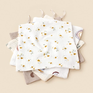 Detailed macro view of soft double-layer muslin cotton baby towels with hanging loops
