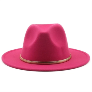 Detail of rose red wool fedora hat with gold metal chain band on a white background