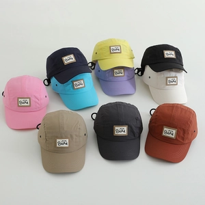 Flat lay display of colorful quick-dry kids camping hats with Bear leather patch detailing