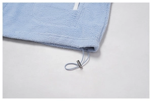 Detail of light blue fleece jacket with adjustable elastic drawstring hem and metal cord lock