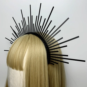 Close-up of black sunburst halo headband with plastic cable ties on gold wig