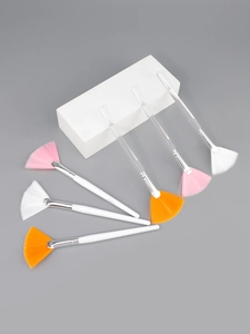 Detailed view of six professional fan brushes with colorful bristles for facial mask care