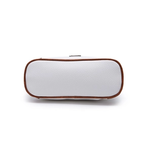 Detail view of the white pebble leather handbag base with brown contrasting trim