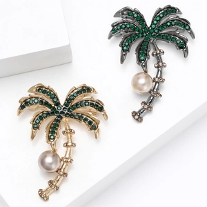 Fashion coconut tree brooches in gold and black with green crystals and pearl detail