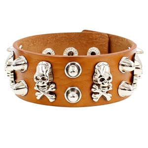Macro view of brown punk leather bracelet with silver skull charms and metal rivets