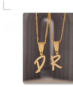Close-up of gold plated letter D and R pendants with micro-paved cubic zirconia stones