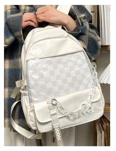 Detail of off-white backpack featuring transparent PVC window and acrylic chain decor