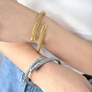 Minimalist twisted cable wire open bangle with ball ends in gold and silver finish