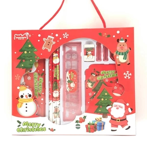 Macro view of Christmas stationery gift set with pencils, ruler, and notebook
