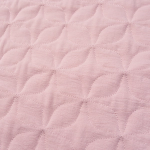 Macro detail of diamond quilted stitching on dusty rose cotton linen jacket fabric