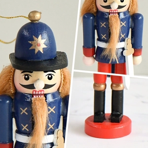 Blue and red 13cm wooden nutcracker soldier ornament with gold details in three views
