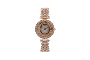Detail of rose gold quartz watch with rhinestones and floating crystals in dial