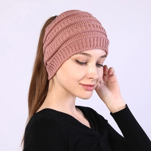Detail of dusty pink cable knit headband showing ponytail hole and ribbed texture