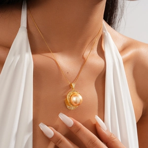 Close-up of a luxury gold flower necklace with pearl and rhinestones on a female model
