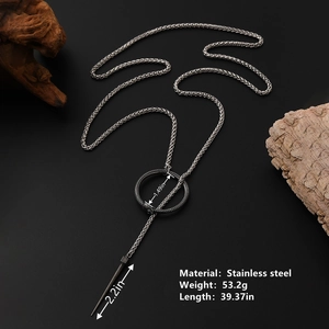 Gothic stainless steel ouroboros ring necklace with spike pendant on dark wood base