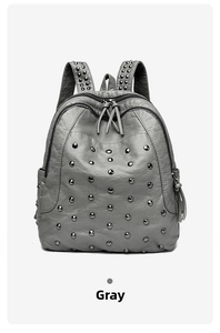 Detail of grey lychee leather backpack featuring punk style black metal rivet studs