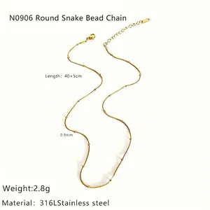 Detail of 316L stainless steel gold snake chain necklace with beads and lobster clasp
