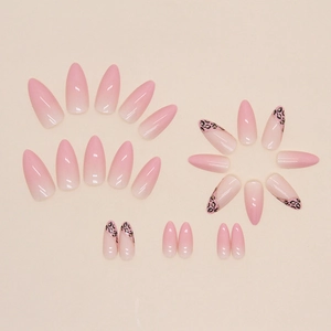 Pink leopard gradient press-on nails in almond shape with French tips and gold lines