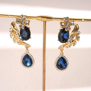 Elegant vintage gold-plated drop earrings with deep blue gems and sparkling floral crystals