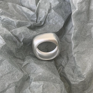 Handmade 925 sterling silver ring with minimalist matte finish on textured background