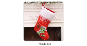 Detailed view of red Grinch Christmas stocking with plush white trim hanging on fireplace