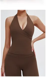 Detail of V-neck halter yoga top and high waist leggings in chocolate brown color