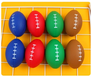 Flat lay of colorful mini PU foam stress relief rugby balls on a yellow grid background